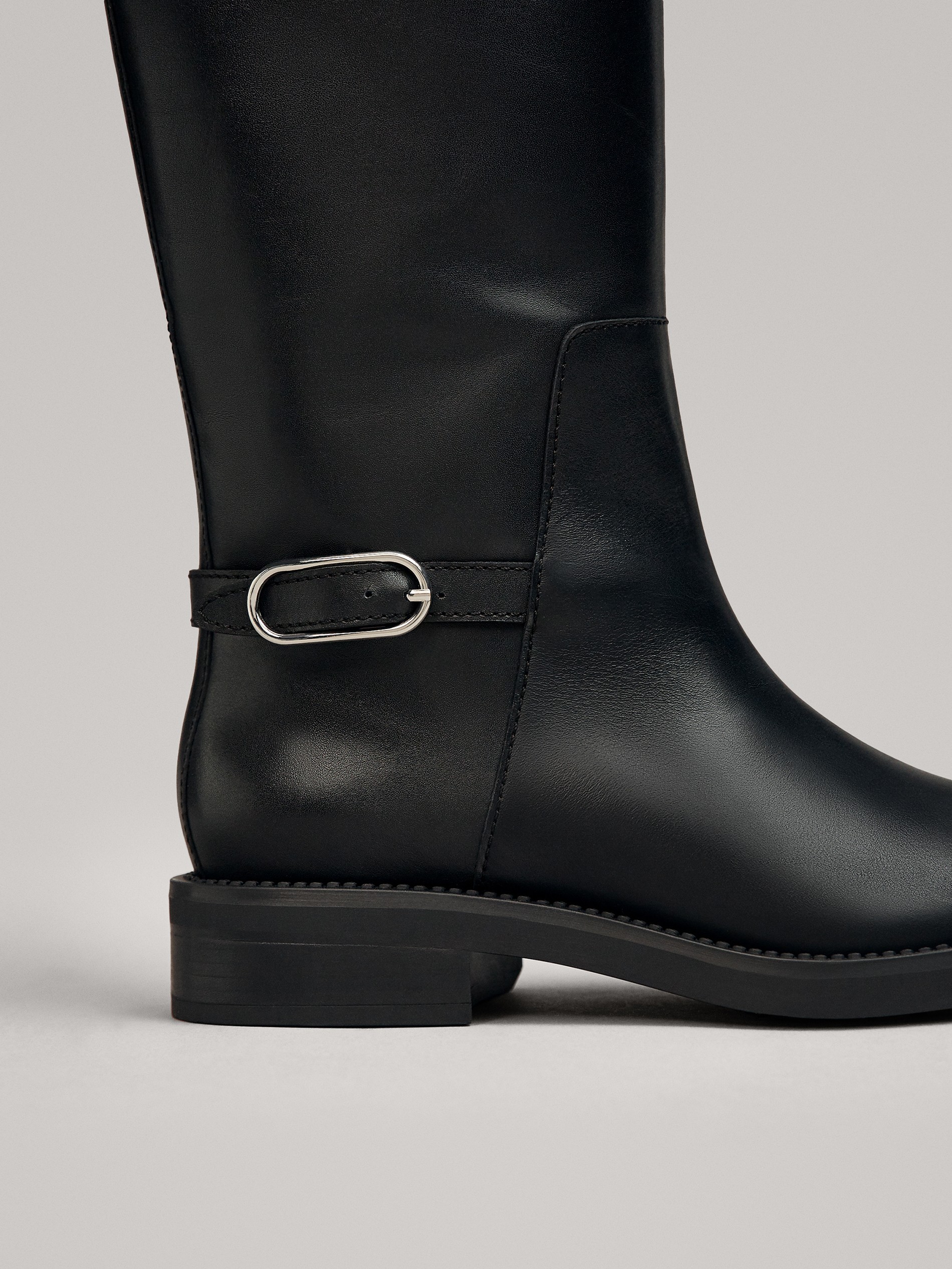 black flat boots with buckles