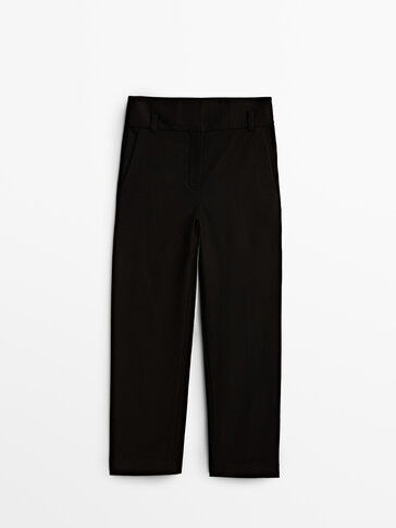 High-waist trousers with flap pockets
