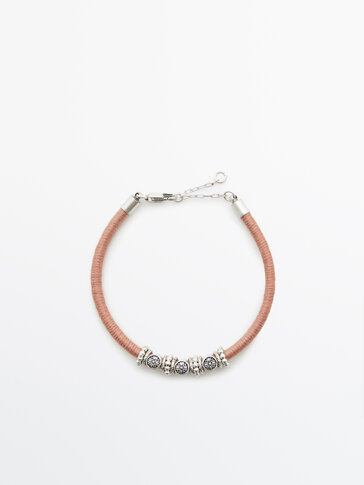 Cord bracelet with silver pieces