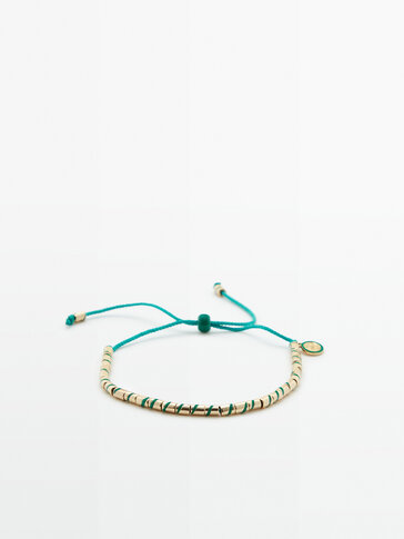 Coloured-thread bracelet with enamelled pieces