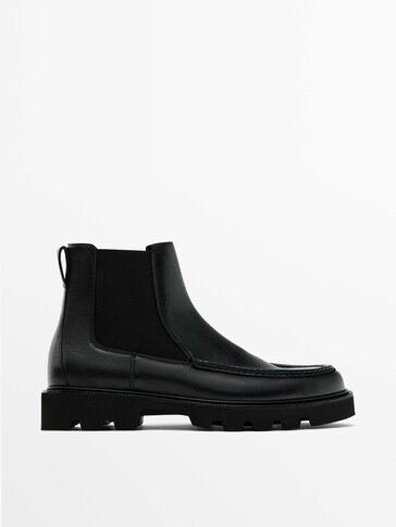 Black Chelsea boots with moc toe detail