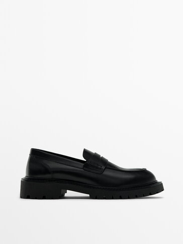 Black leather track sole loafers
