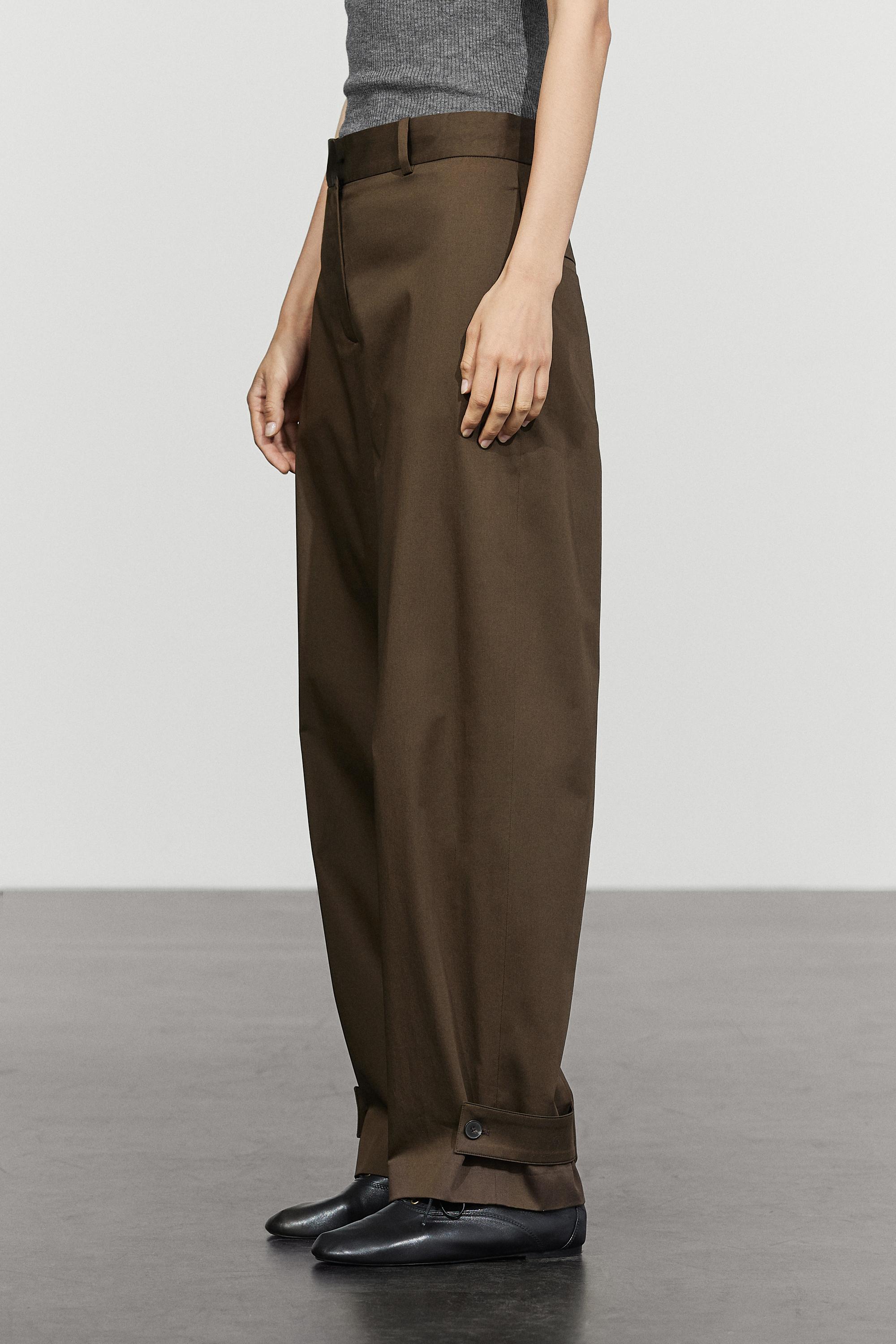 Pants with button-tab hem detail