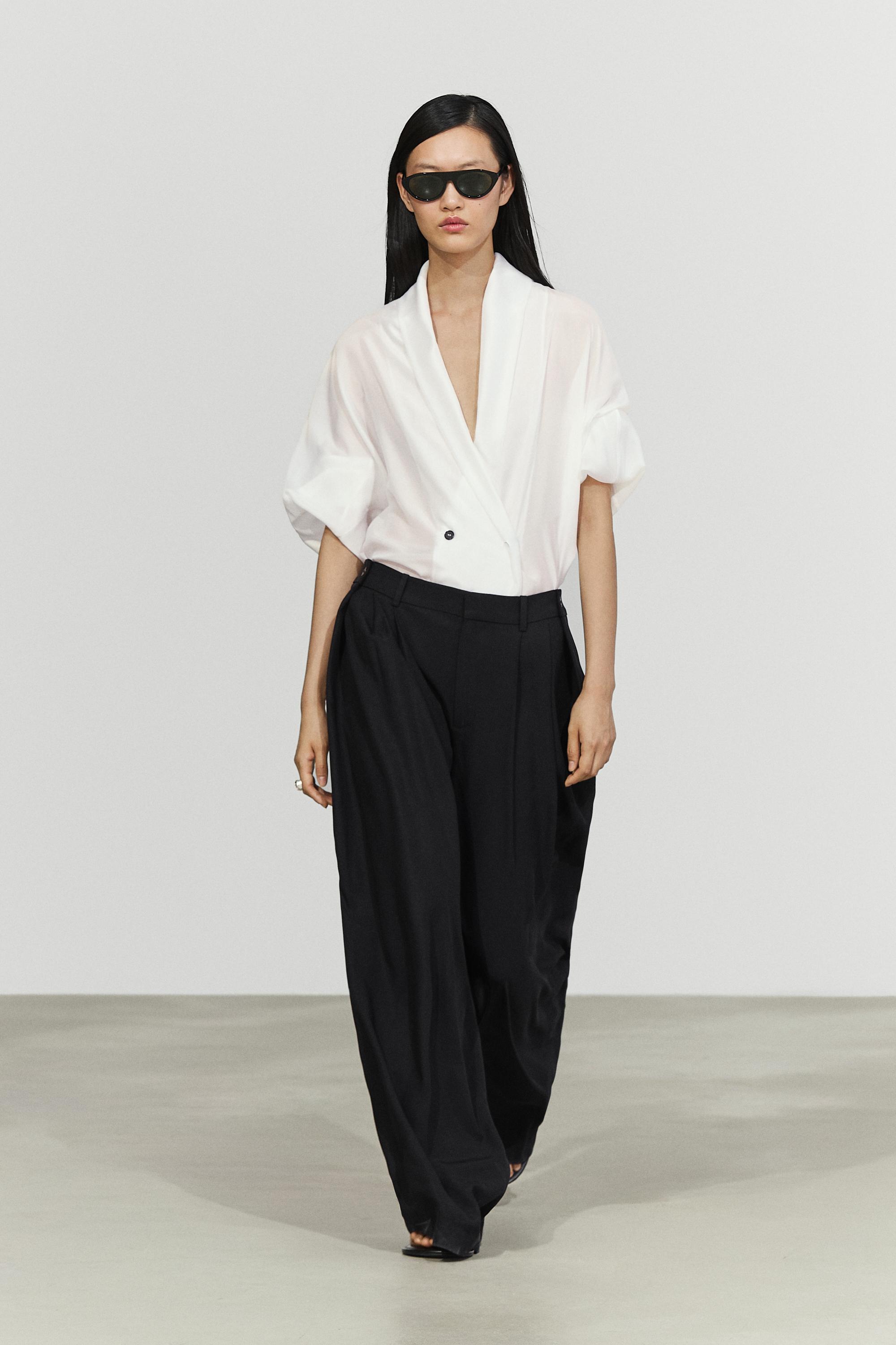 Flowing pleated pants with button detail