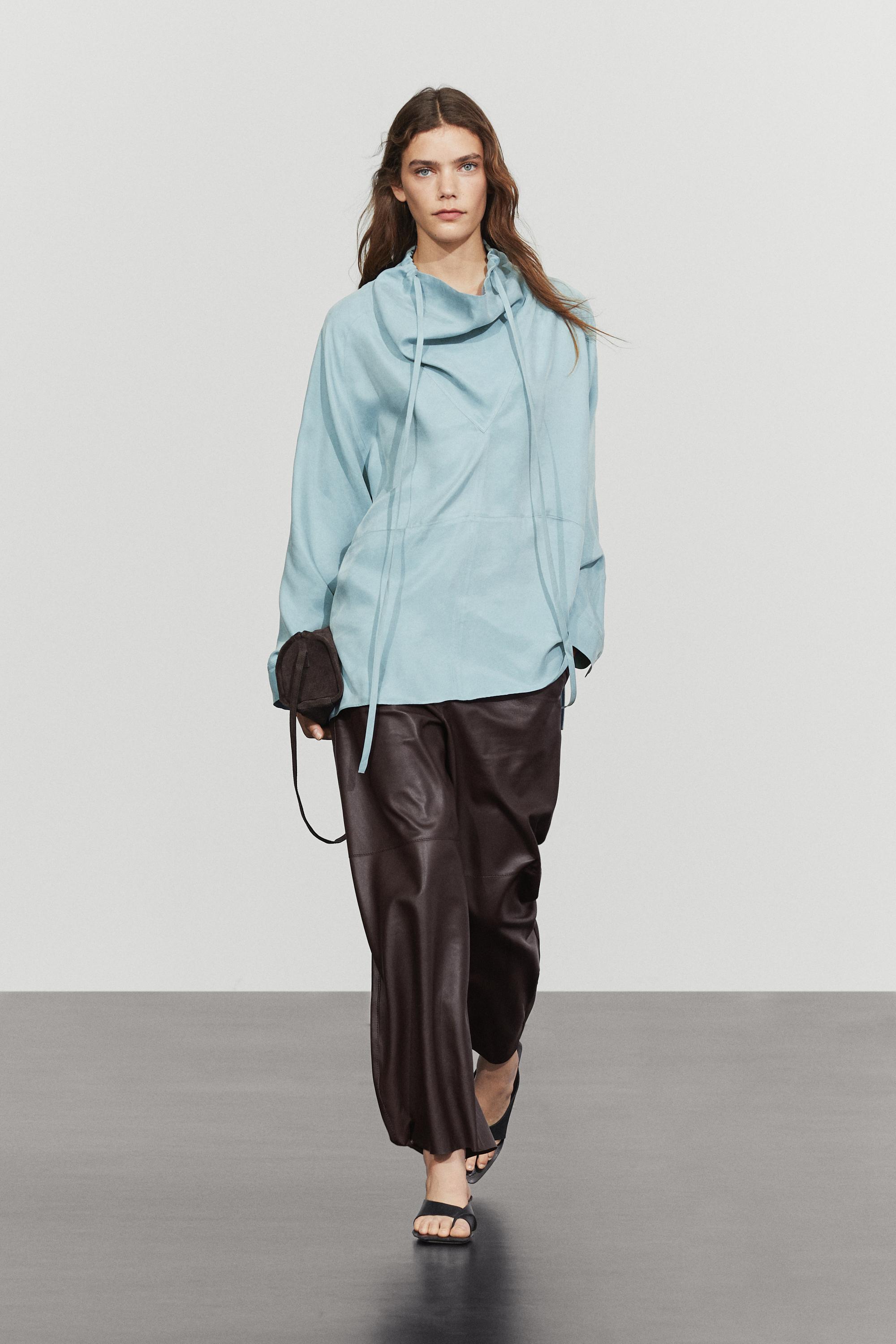 Flowing shirt with high collar and drawstring detail