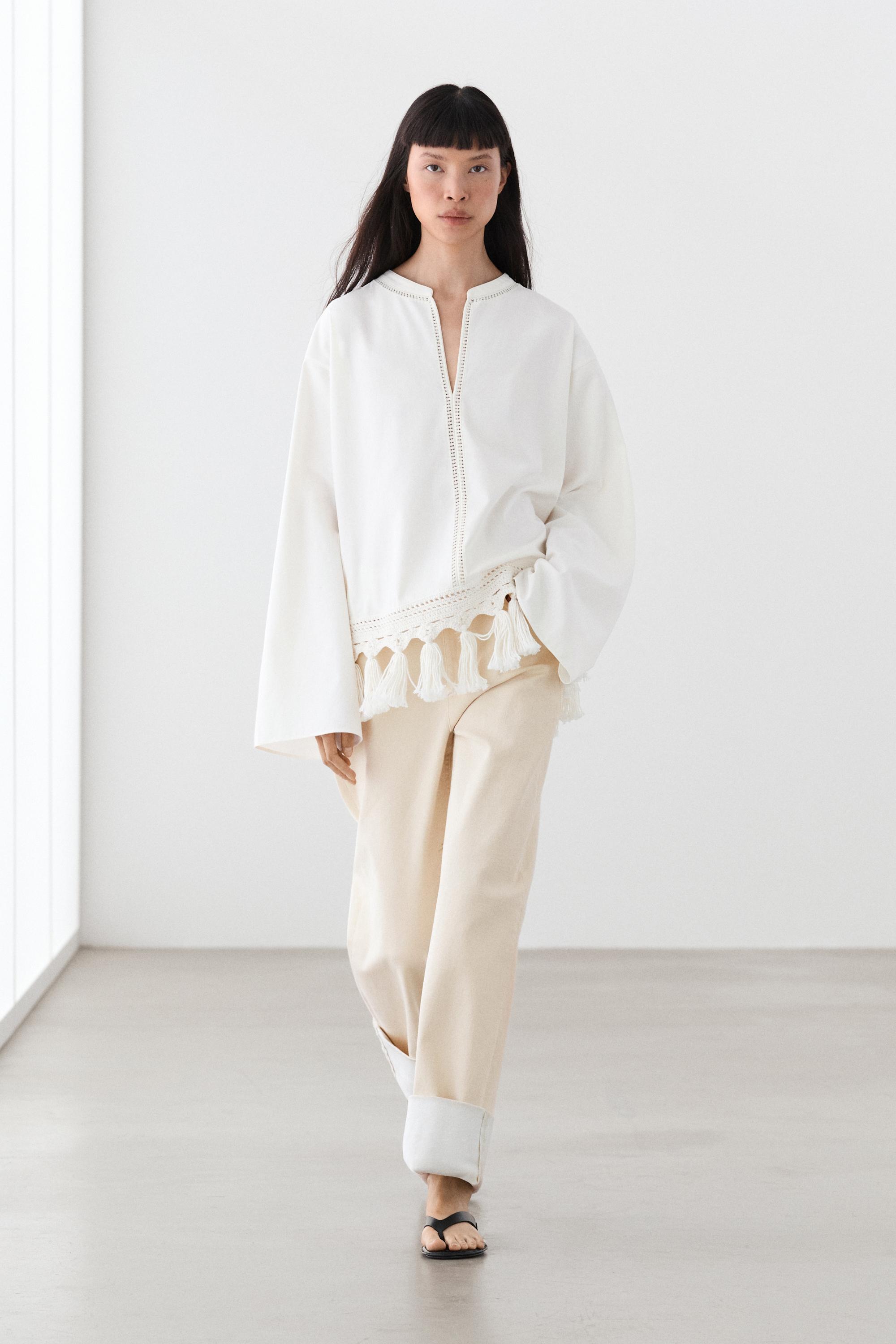 Embroidered blouse with fringed hem