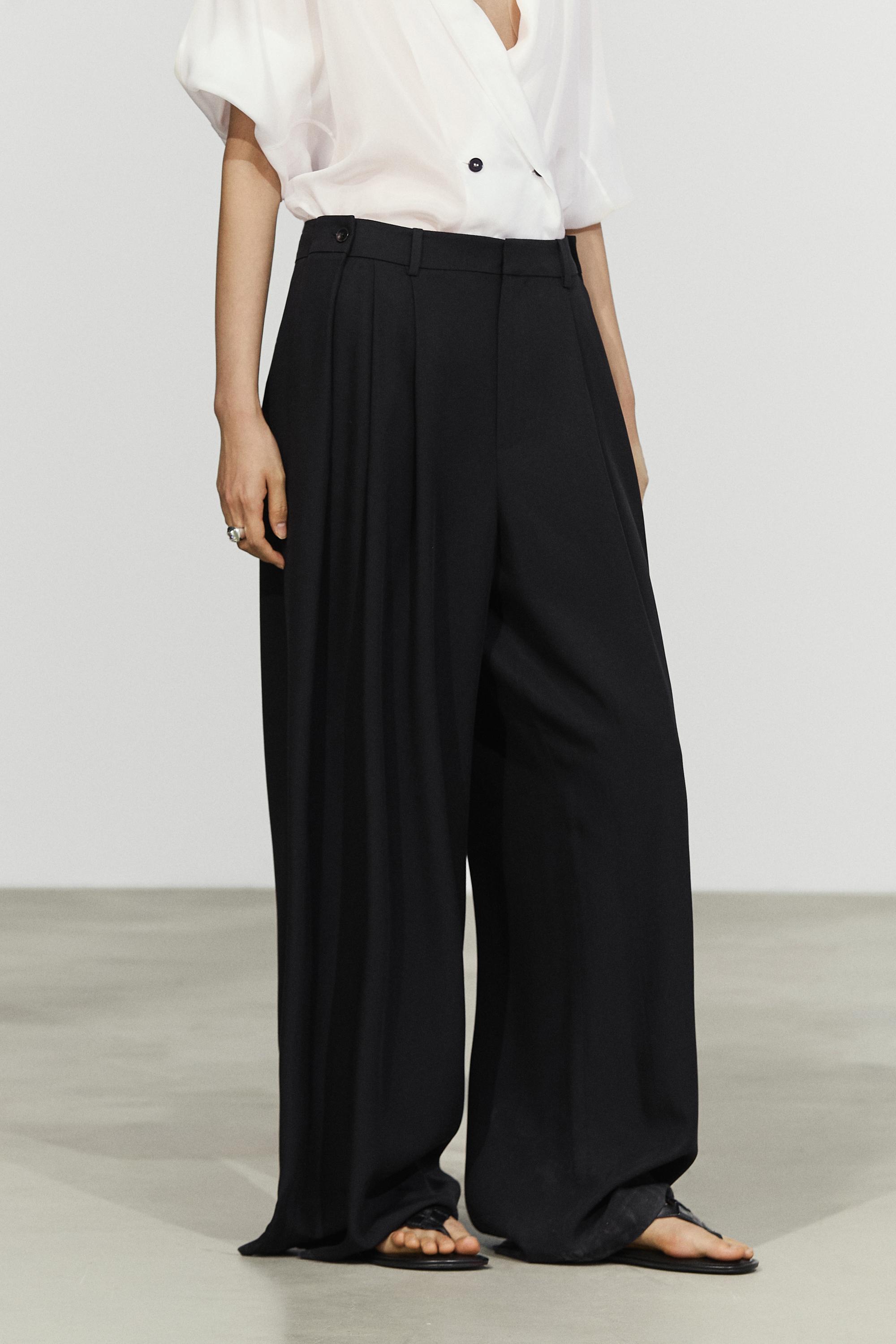 Flowing pleated pants with button detail