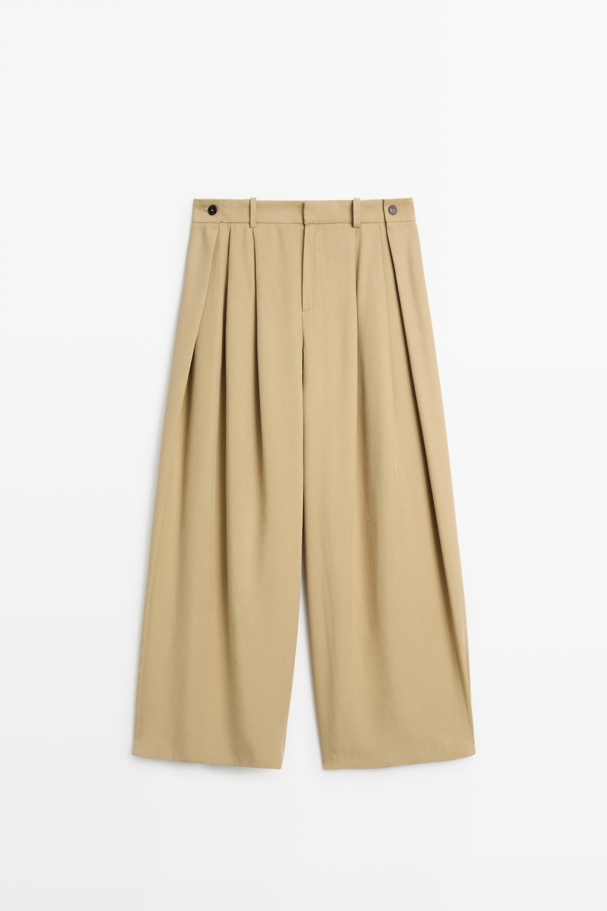 Flowing pleated pants with button detail