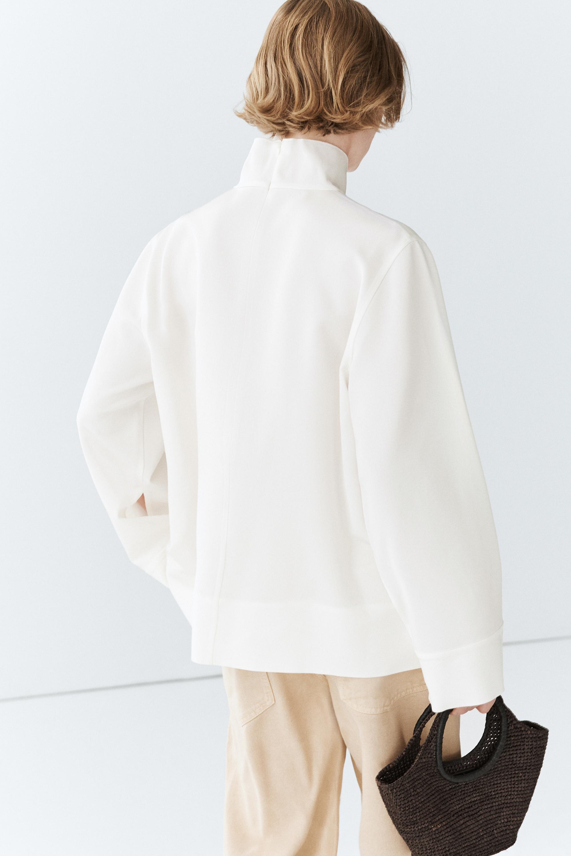 High neck blouse with hem detail