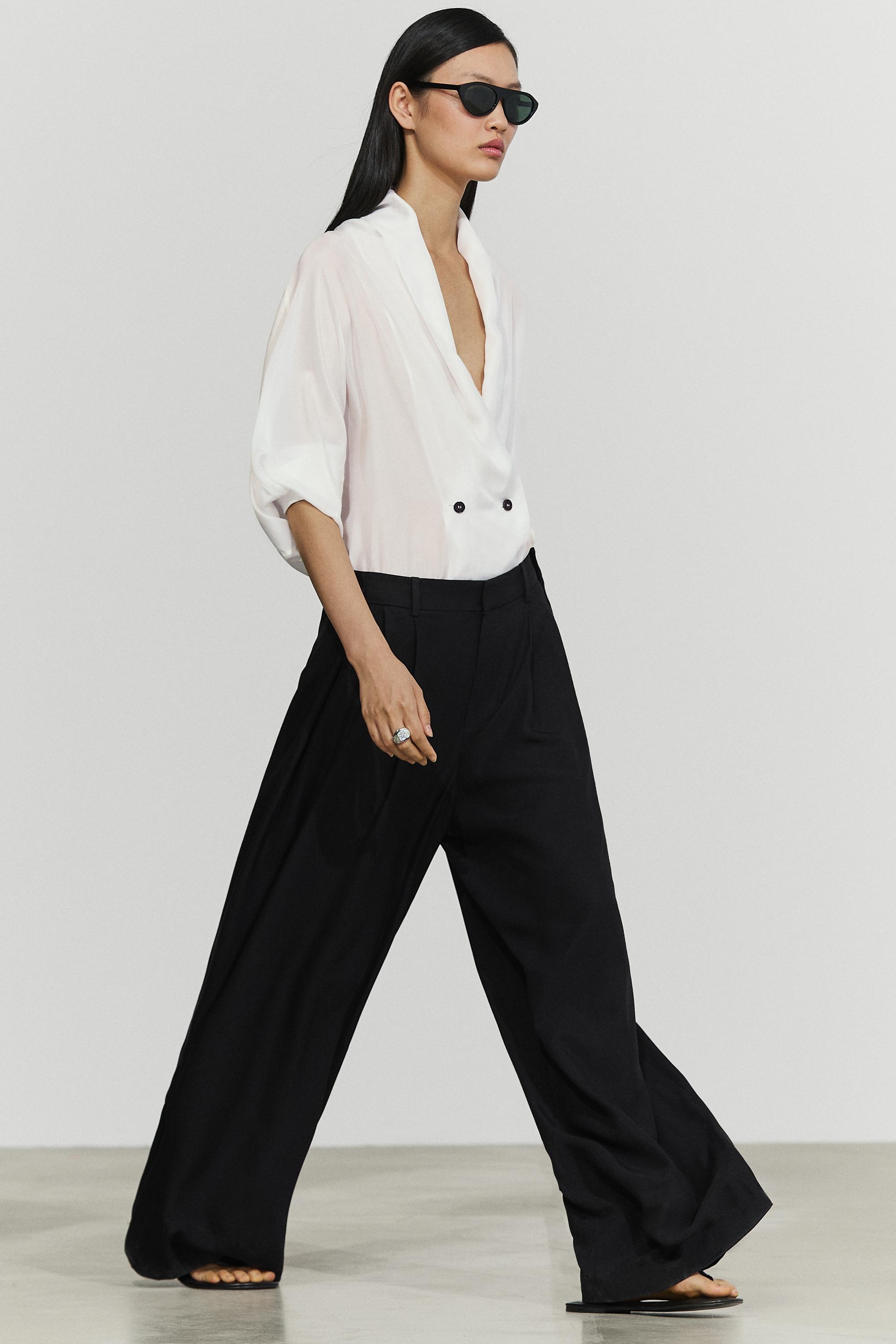 Flowing pleated pants with button detail